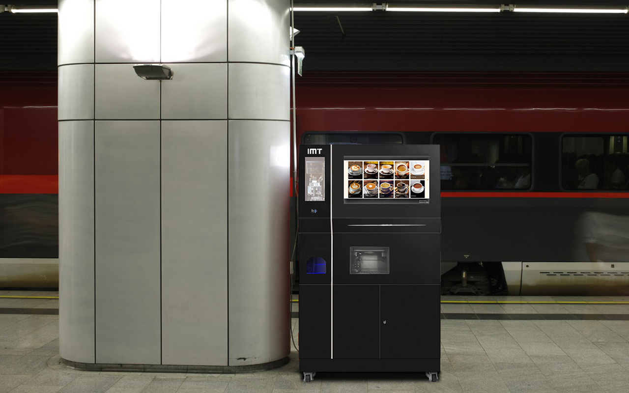 Black ice coffee vending machine in a train station.