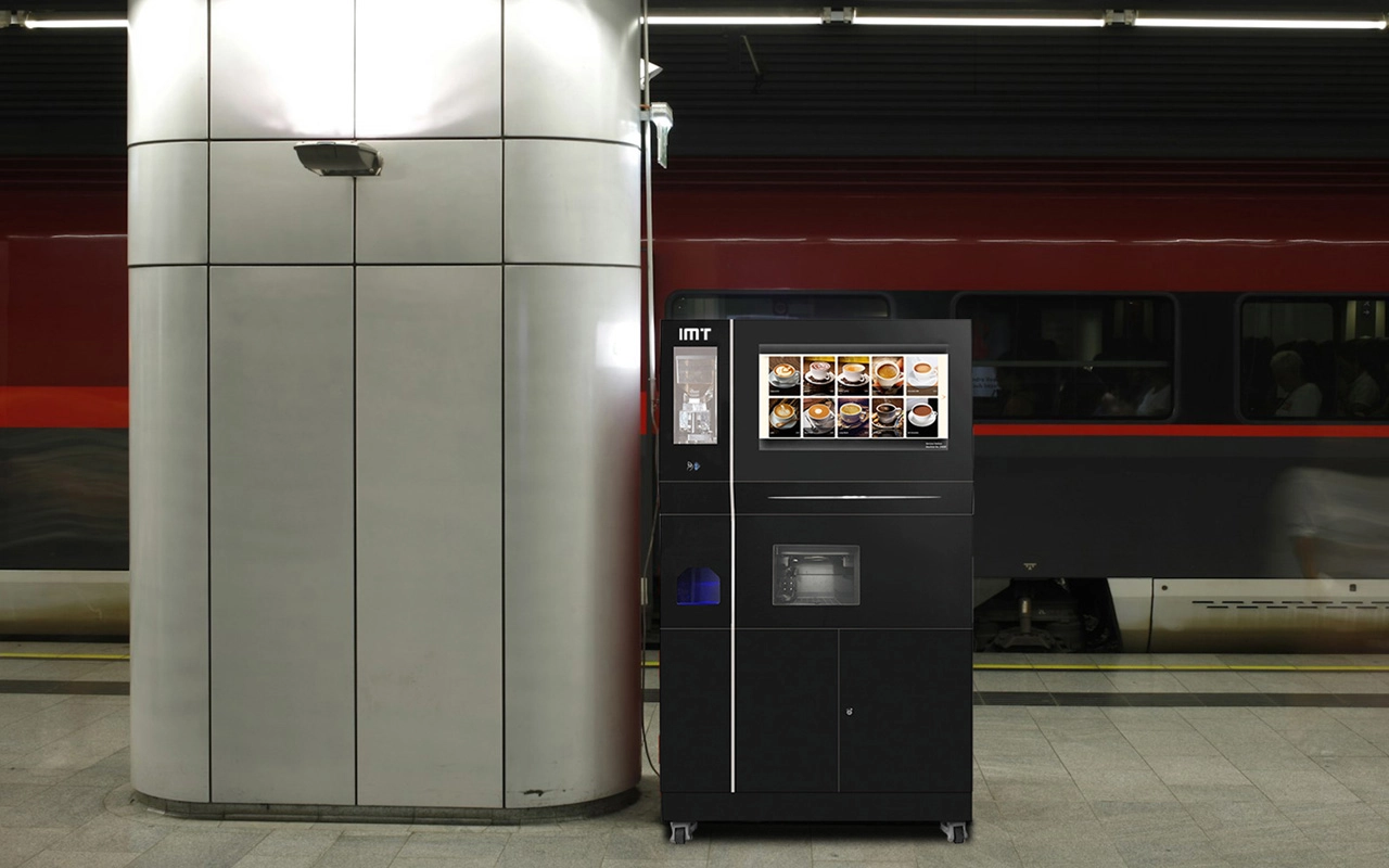 Black ice coffee vending machine in a train station.